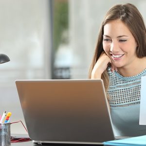 Student studying or entrepreneur working with a laptop and notes at home